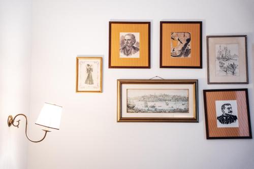 a group of framed pictures on a wall at GRANDE HOTEL PARIS by STAY HOTELS in Porto