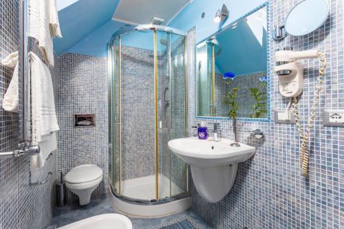 a bathroom with a shower and a sink and a toilet at Casa Mare Sea View in Giardini Naxos