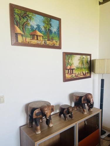 a shelf with three elephant statues on top of it at GreenPark Garden Villa Family Apartments Near Tokaj in Szerencs