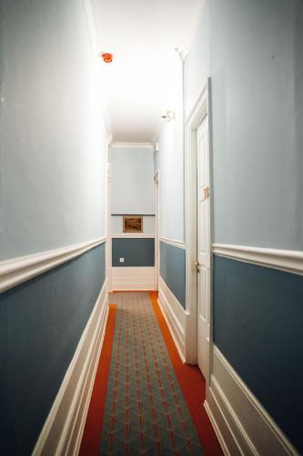 a hallway with blue and white walls and a door at GRANDE HOTEL PARIS by STAY HOTELS in Porto