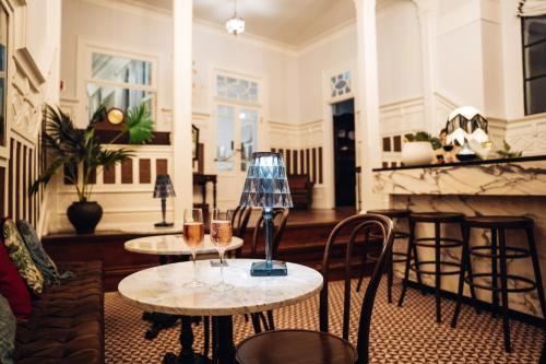 a living room with two tables and a fireplace at GRANDE HOTEL PARIS by STAY HOTELS in Porto