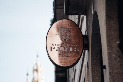 a mirror hanging on the side of a building at GRANDE HOTEL PARIS by STAY HOTELS in Porto