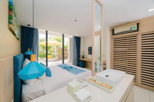 a bedroom with a large bed and a bathroom at Ocenami Resort 3 pn in Long Hai