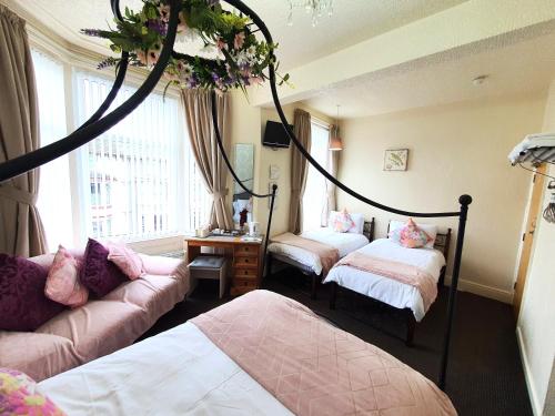 Ένα ή περισσότερα κρεβάτια σε δωμάτιο στο Windsor House Hotel