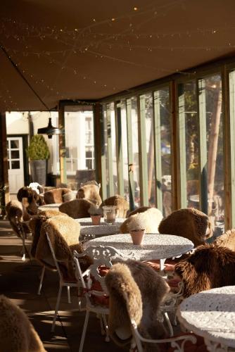a room with tables and chairs with teddy bears on them at The Grosvenor Arms in Hindon
