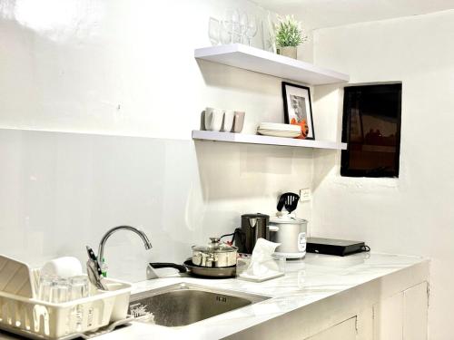 a kitchen with a sink and a counter top at Cozy 3BR Bungalow House with Netflix & Games in Davao City