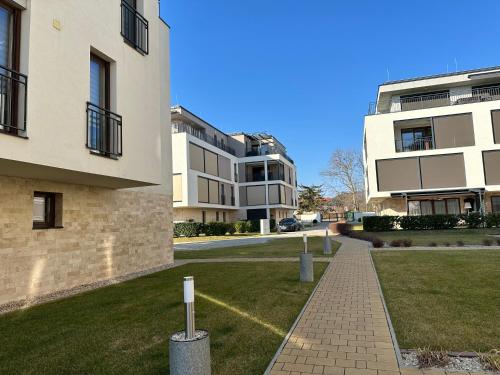 a walkway between two buildings in a city at Royal Apartman am See in Csopak