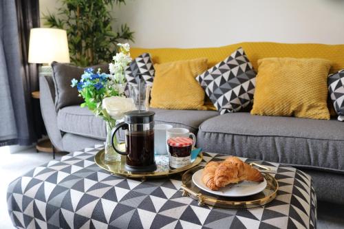 a living room with a couch and a coffee table at 3 Bed Home for Contractors & Relocators with Parking, Garden & WiFi 5 mins walk to Town Centre & Train Station in Stafford