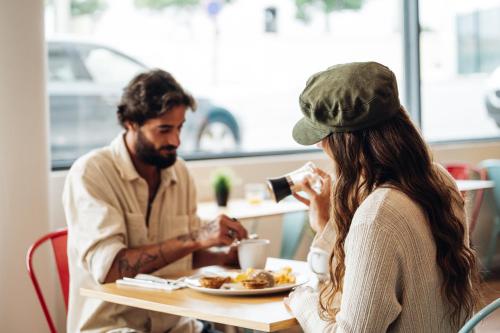 a man and a woman sitting at a table eating food at Stay Hotel Lisboa Aeroporto in Lisbon