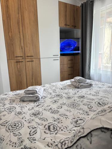 a bedroom with a bed with towels on it at APARTMENT SIYANA in Panagyurishte