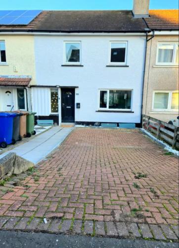 a brick driveway in front of a white house at Super luxury 2 bedroom, full house sleep 5 with garden & parking close to airport in Elderslie