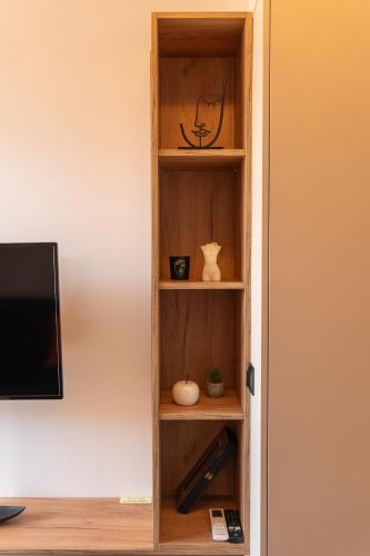 a book shelf with vases and other items on it at Orange Luxury apartment in agrinio in Agrinion
