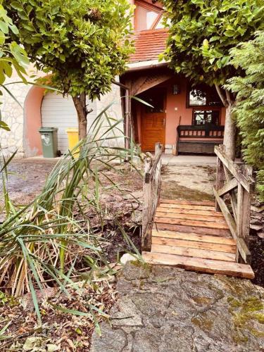 a house with a wooden staircase leading to a house at GreenPark Garden Villa Family Apartments Near Tokaj in Szerencs