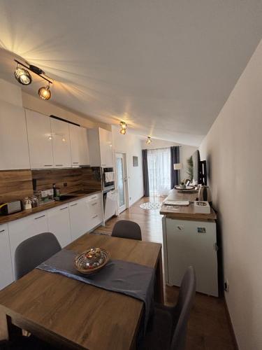 a kitchen and dining room with a wooden table at APARTMENT SIYANA in Panagyurishte