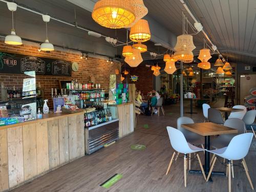 a restaurant with a table and chairs and lights at Tor View Lodge with Hot Tub & Sauna - Spa Resort - South Devon in Chudleigh Knighton