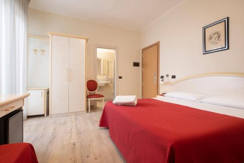Ένα ή περισσότερα κρεβάτια σε δωμάτιο στο Hotel Mondial