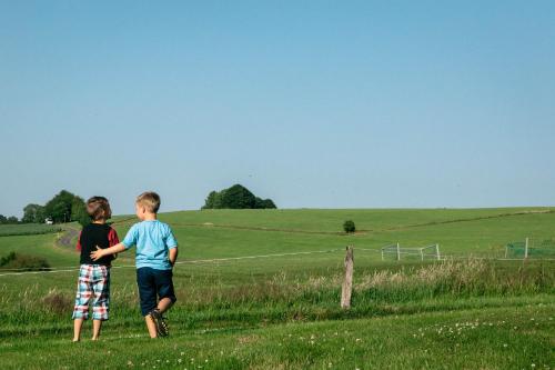 two young boys standing in a field at Gasthof Spelsberg in Altena