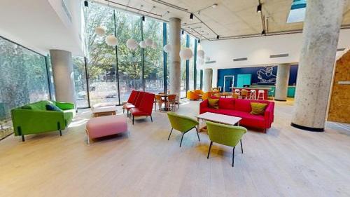 a large room with colorful furniture and tables and windows at For Students Only at iQ Brighton in Brighton & Hove