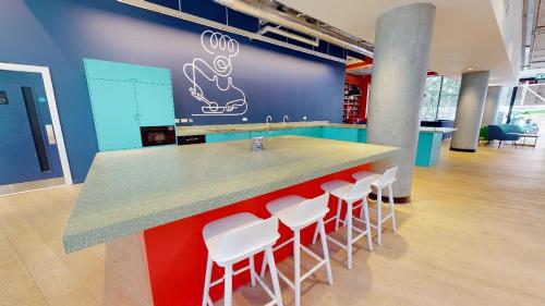 an office with a counter with stools and a bar at For Students Only at iQ Brighton in Brighton & Hove