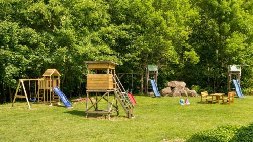 a group of playground equipment in a park at Ferienwohnung Ferienhäuser am Brocken, 60 qm, 2 Schlafzimmer in Ilsenburg