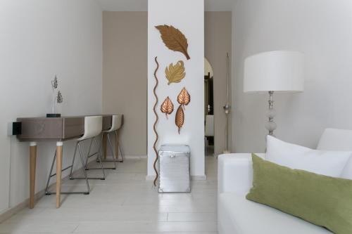a living room with a couch and a table at Aparthotel Dei Mercanti in Milan