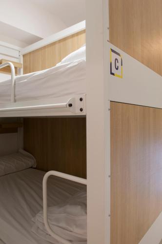a small room with two bunk beds in it at UP Hostel Valencia in Valencia
