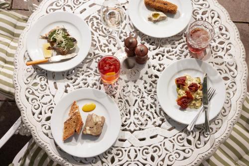 a white table with plates of food on it at The Grosvenor Arms in Hindon