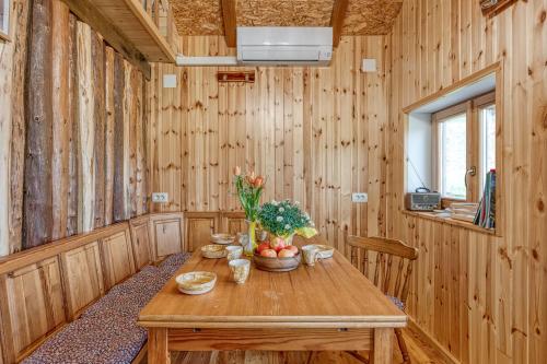 a wooden room with a wooden table with flowers on it at Enchanted Cosy Chalet Kalanka - Happy Rentals in Kal