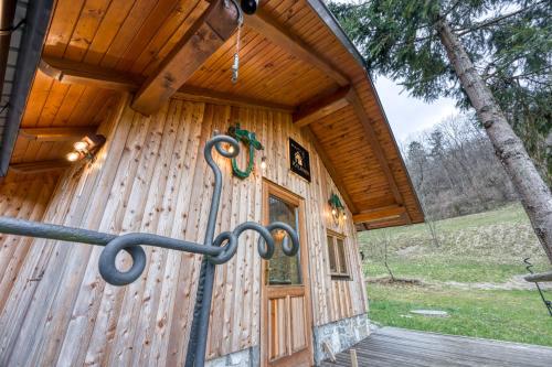 a wooden cabin with a wooden door and a porch at Enchanted Cosy Chalet Kalanka - Happy Rentals in Kal