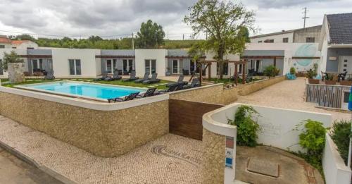 an image of a house with a swimming pool at Charming House with Shared Pool in Atalaia, 110 m² in Lourinhã
