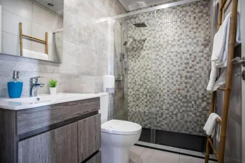 a bathroom with a toilet and a shower and a sink at Charming House with Pool in Atalaia in Lourinhã