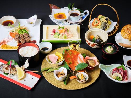 a table with plates of food and bowls of food at あさぎり山荘ひばり in Asagiri