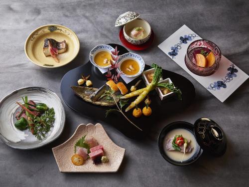 a table with plates of food and bowls of food at Hakone Retreat villa 1/f in Hakone