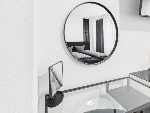 a bathroom with a mirror and a glass sink at Loft & Living am Geiseltalsee in Braunsbedra