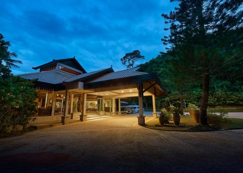 a building with a pavilion in a park at The Taaras Beach & Spa Resort in Redang Island