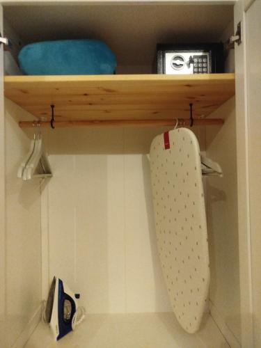 a shelf in a bathroom with a knife and a board at L'Accademia dei Sogni in Sassari