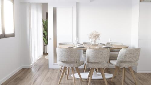 a dining room with a wooden table and chairs at Vieira Residence in Praia da Vieira