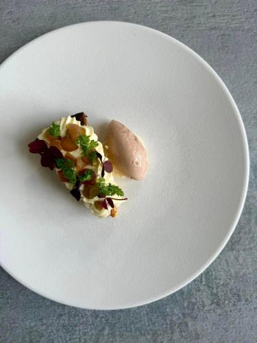 a white plate with a piece of food on it at Vejlsøhus Hotel and Conference Center in Silkeborg