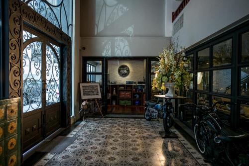an entrance to a building with a bike parked in a hallway at Nandha Hotel in Bangkok