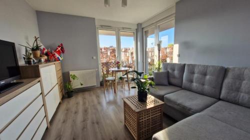 a living room with a couch and a table at Osiedle Morskie in Pogórze