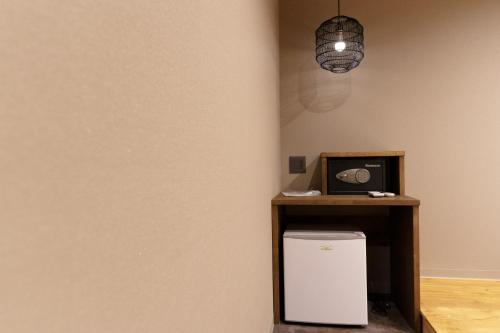 a corner of a room with a small white refrigerator at Hotel San Hiroshima in Hiroshima