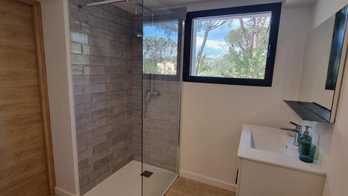 y baño con ducha acristalada y ventana. en Villa Antassi enjoy the sun, en Grimaud