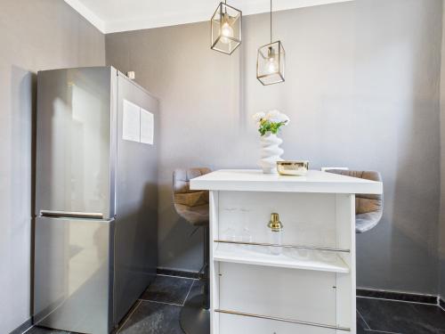 a kitchen with a white counter and a refrigerator at Loft & Living 2 am Geiseltalsee WLAN Netflix Parkplatz in Braunsbedra