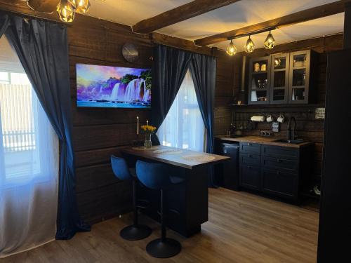 a kitchen with a bar and a tv on the wall at Cozy Stay - Self Check-In, Free Parking in Tartu