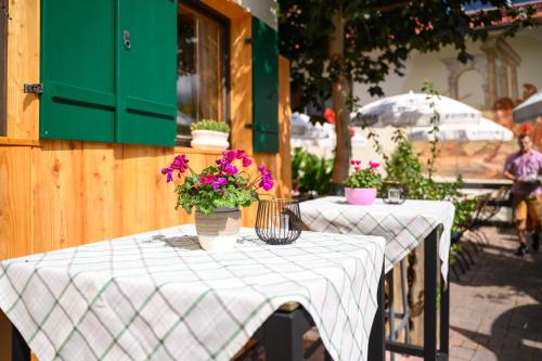 a couple of tables with flowers on top of them at Hotel Restaurant Frühlingsgarten in Füssen