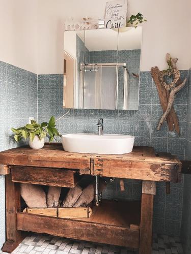 a bathroom with a sink and a mirror at Ferienwohnungen Kaiser Franz in Krün