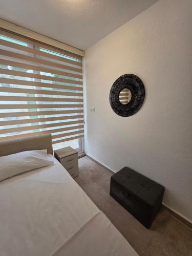 a bedroom with a bed and a mirror on the wall at Sevinc Akasya Luxury Villa in Milas