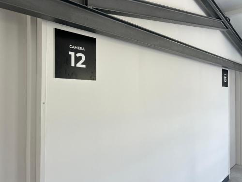 a garage door with a clock on top of it at 87029house in Scalea