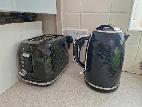 two coffee makers sitting next to each other on a counter at Canny Hyem in Birtley