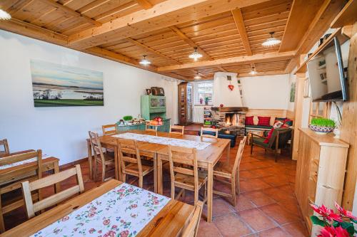 a kitchen and dining room with a table and chairs at Apartment House Ančkin kot in Cerknica